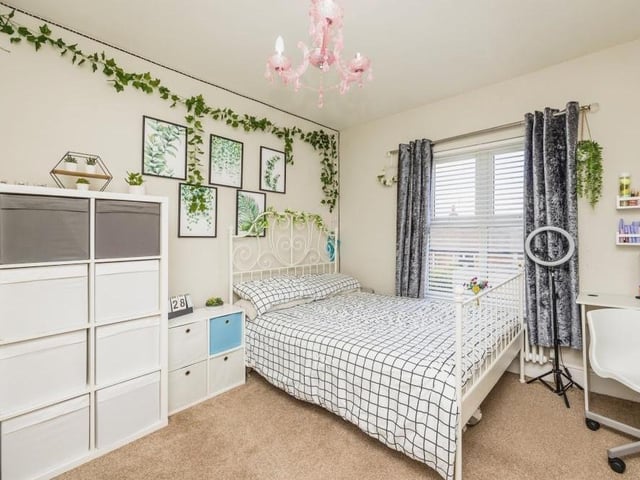 This bedroom exudes charm. As you can see, it is also a good size, with plenty of space for storage.