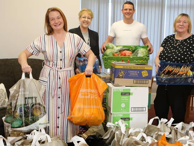 Mansfield Ambulance technician Loretta Leeming and her husband Phil handing over an enormous amount of food she has collected to Linda Gannon and Adele Hopkinson of the Brunts Charity