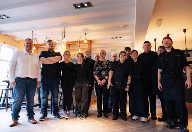 Staff pose for a photo as the site reopens after a 'refreshing' refurbishment.
