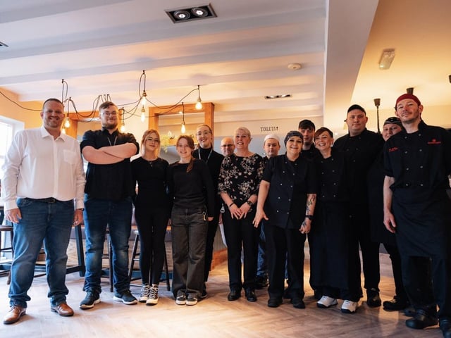 Staff pose for a photo as the site reopens after a 'refreshing' refurbishment.