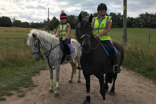 Sarah Howarth (right) on her 13-year-old Dales cross horse, Bella, and daughter Phoenix on 20-year-old pony, Dotty.