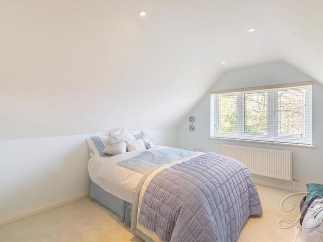 Bedroom number three is a bijou number with a carpeted floor and a window facing the back of the house. It also has access to an en suite.
