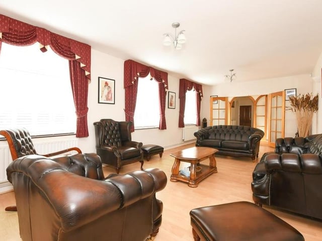 The sitting room, spanning 26 feet, is the epitome of luxury, wouldn't you agree? A ravishing place to relax.