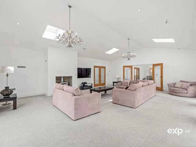 This generously sized reception room is suitably relaxed but still exudes a sophisticated mood with its refined décor and continuation of carpeted flooring with underfloor heating. The room features a modern fitted ‘Firebelly’ wood-burning stove, perfect for cosy family evenings.