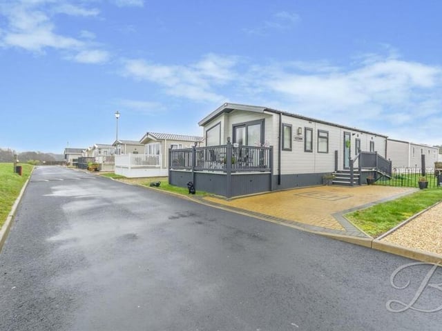 Let's step outside now and start with an image that shows how the mobile home sits proudly within Tall Trees Park, which is beautifully kept.