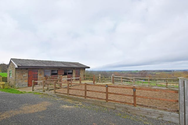 Here's the stone-built stable block, comprising of three stables and a tack room. To the front of the stable block, there is a concrete hardstanding.