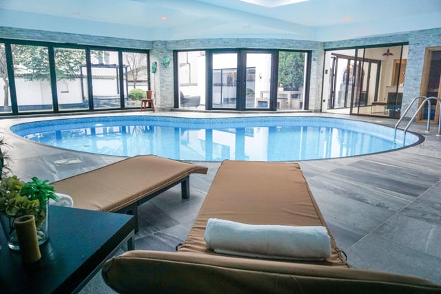 The kidney-shaped heated swimming pool has a shallow and deep end. The room has a vaulted ceiling with skylight and spotlights. Access to the garden is via bi-fold doors and a sauna and changing rooms/shower rooms can be found around the pool.