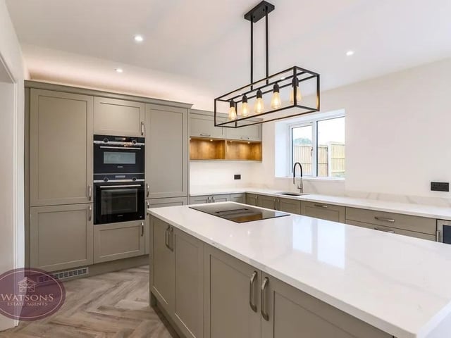The kitchen has a range of matching shaker style wall and base units with marble work surfaces incorporating an inset 1.5 bowl sink. Integrated Siemens appliances including; waist height double electric oven, dishwasher, fridge freezer and wine cooler. Central island offering more storage with marble work surface incorporating an induction hob with downdraft extractor. UPVC double glazed window to the rear, ceiling spotlights and laminate wood flooring with underfloor heating.