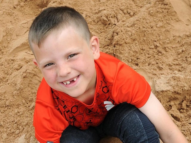 Joe Newbury, eight, from Mansfield Woodhouse, hides his feet in the Mansfield beach.