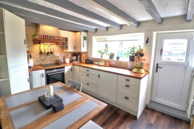 Let's start our tour of the Sherwood Rise cottage in the high-quality dining kitchen, where a host of integrated appliances include a fridge freezer, dishwasher, washing machine, oven, induction hob with extractor hood over, and wine fridge.
