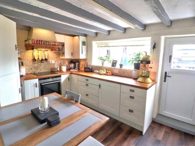 Let's start our tour of the Sherwood Rise cottage in the high-quality dining kitchen, where a host of integrated appliances include a fridge freezer, dishwasher, washing machine, oven, induction hob with extractor hood over, and wine fridge.