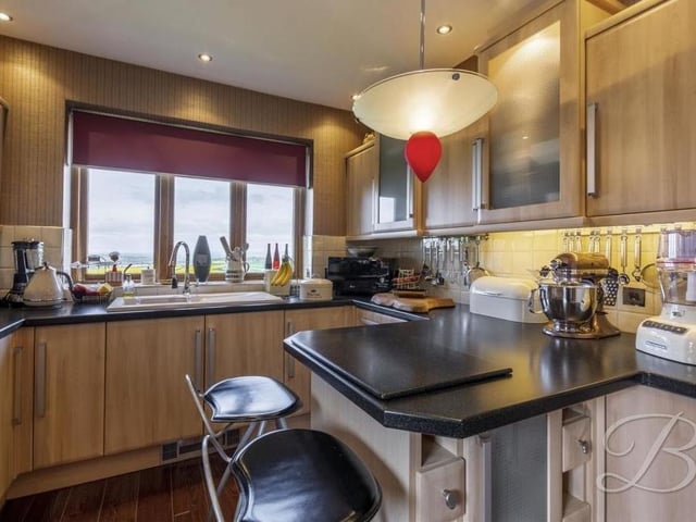 It;s not hard to imagine the kitchen being busy and bustling. It also features an inset sink and drainer with mixer tap, splash tiling, downlights and wooden flooring.