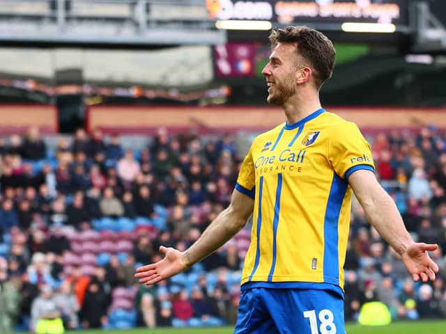 Rhys Oates celebrates after scoring their first goal during the English FA Cup fourth round football match between Burnley and Mansfield Town at Turf Moor in Burnley, north west England on February 14, 2026. (Photo by Paul Currie / AFP via Getty Images)