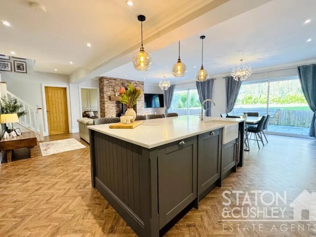 The kitchen offers a range of fitted wall and base units, Quartz worktops, a range cooker and hob, a double fridge/freezer, dishwasher and wine cooler.