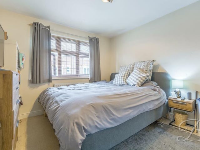 This comfortable bedroom has plenty of space for furniture and storage space.