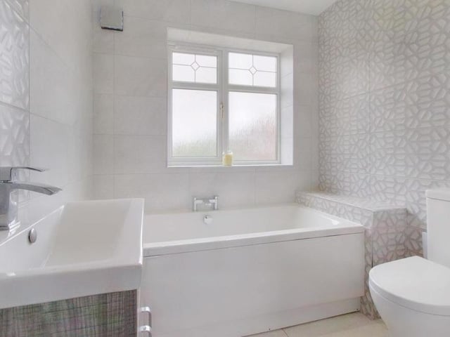 The last room to look at within the house is the family bathroom. It is light and crisp, offering white fittings and a vanity sink with integrated storage.