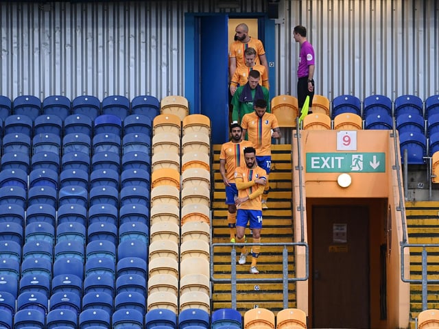 James Perch leads his team out for the Sky Bet League Two match between Mansfield Town and Forest Green Rovers on March 23, 2021. Sporting stadiums around the UK remained under strict restrictions with no fans allowed inside.