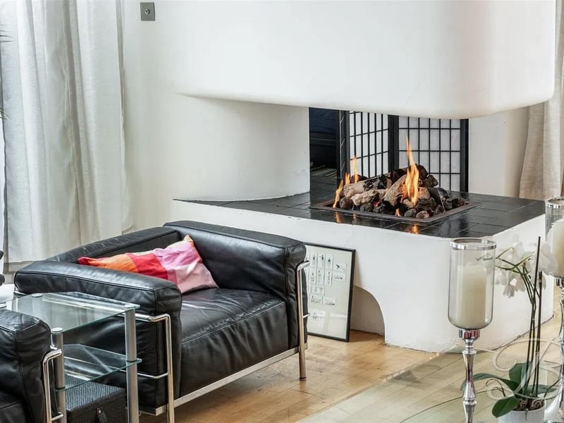 The sitting room boasts a captivating feature fireplace that adds warmth and character, creating a grand yet inviting atmosphere.