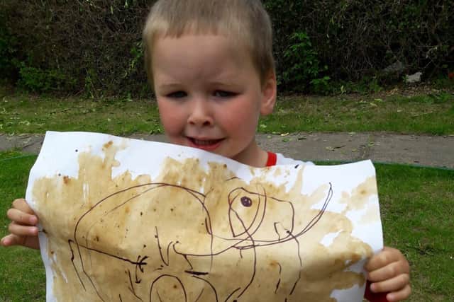 Two-year-old Jacob Duke with his cave painting