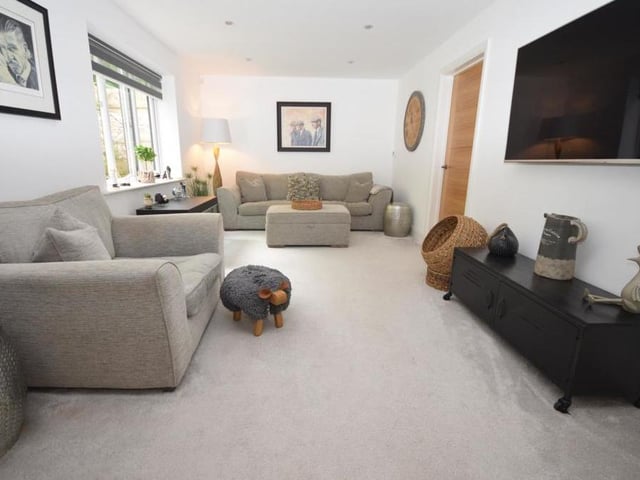 At one end of the open-plan dining kitchen is a family living area, with relaxed seating, a softer decor, sumptuous carpeting and underfloor heating. The whole of the kitchen and living space benefits from atmospheric downlighting.