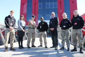 Major Goodwin, third left, with uniformed protective services staff, students and college principal Andrew Cropley, third right.