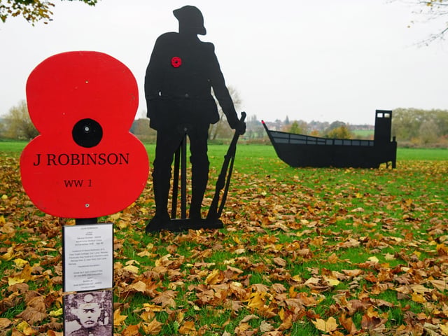 The display, now over a mile long, features numerous wooden poppies with the names of those commemorated on the cenotaph.