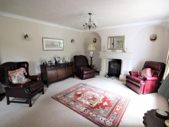 Let's start our tour of the Ollerton cottage in the lengthy lounge, which features a marble fireplace with log-burner.