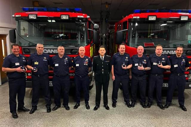 Station Manager Jonathan Smith, centre, presented Queen's Platinum Jubilee medals to nine long-serving firefighters at Shirebrook Fire Station.