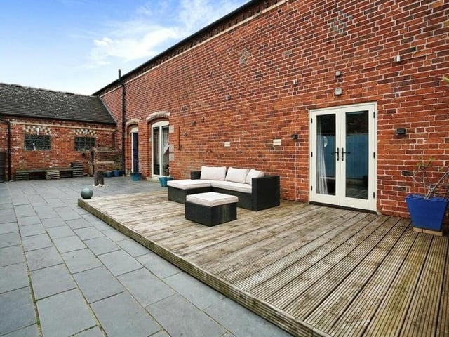 By the patio is this decked seating area, which is a delightful spot in the summer sunshine.