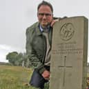 Veteran Chris Butler by the damaged war grave in Kirkby.