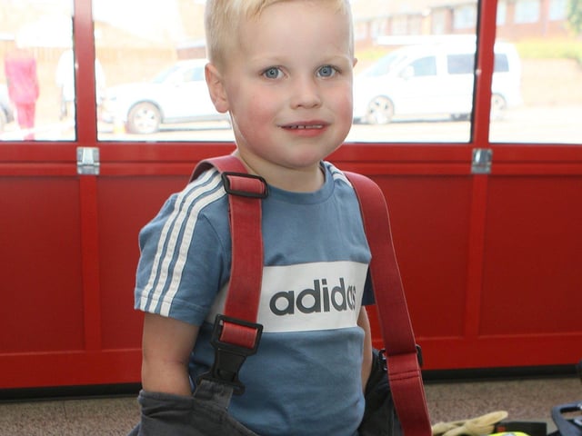 Little Harrison Bourn found the fire kit a bit on the big size.