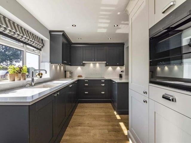 Let's start our tour of the £675,000 Kirkby bungalow in the stunning, modern kitchen, which comes complete with a range of matching units and cabinetry, complementary work surfaces and an inset sink.