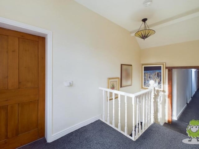 At the top of the stairs, you are greeted by this first-floor landing that guides you to all five bedrooms.