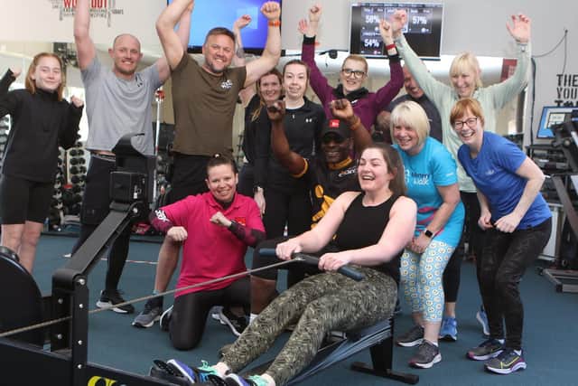 Members of the Fitness Box gym in Mansfield Woodhouse cheer on Rachel Pickering on the rowing machine during their Ironman Challenge to raise money for defibrillators.