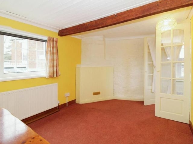 This upstairs bedroom might not be fully furnished at the moment, but character features such as the ceiling beams add to its appeal.