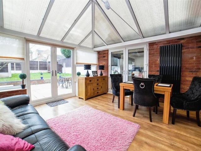 The conservatory is a bright and welcoming space, blending indoor comfort with an outdoor feel.