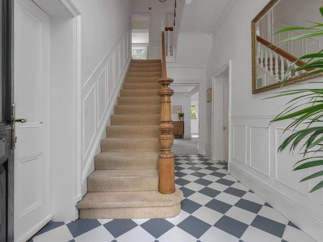 As we plan to move upstairs, here is the entrance hall with its tiled floor, coving to the ceiling and staircase to the first floor's galleried landing.