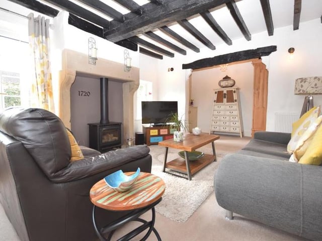 A second glance at the lounge, which also includes an interesting and quirky nook area that has been cleverly fitted with a bank of stylish storage cupboards. The sunny south-facing room enjoys plenty of natural light thanks to windows at the front and side, and French doors that open out onto a pretty courtyard garden.