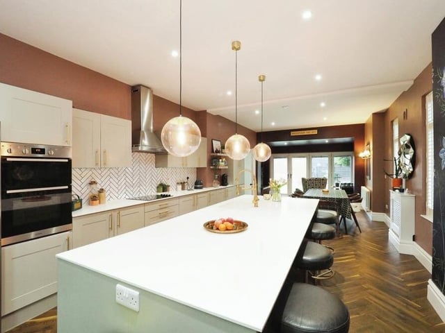 Another view of the kitchen dinner, which is equipped with several integrated appliances, including double electric oven, induction hob and dishwasher. There is also space for an American fridge freezer,