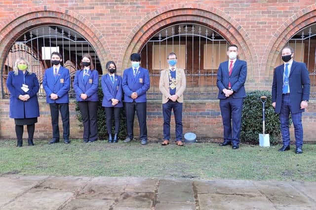 Students at Mansfield's Queen Elizabeth’s Academy join principal Kimberley Willmot, mayor Andy Abrahams, Neil Holmes, chief education officer at Diverse Academies Trust and Peter Mabbott, trustee, of Diverse Academies Trust at the ceremony to bury the capsule.