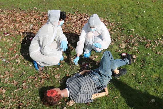 Dummy run: students used specialist equipment including evidence markers, plastic sheets, tape measures, swabs and containers, in order to determine the cause of "death."