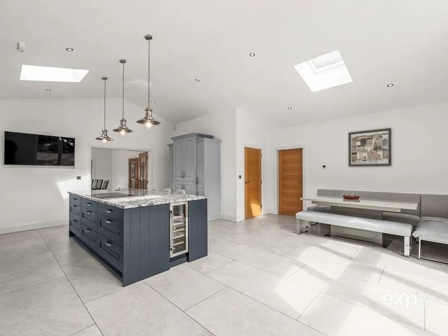 The perfect place for the family to gather, the island incorporates a functional breakfast bar offering relaxed kitchen dining. Here there is a built-in wine rack and wine fridge.