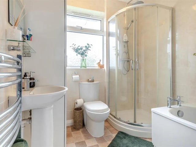 The bathroom is the perfect place to relax and unwind after a busy day, featuring a panelled bath and separate tiled shower cubicle with rainfall shower plus additional shower handset.
