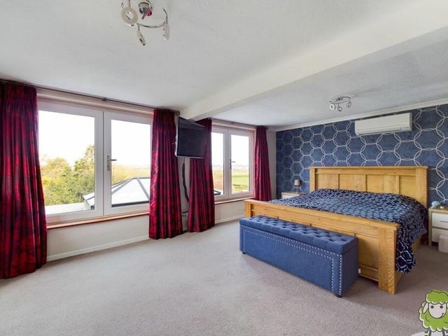 Time to move upstairs now, and of the six bedrooms at the Church Lane house, this is the master. An extra-large double bedroom, it has its own en suite facilities and offers fantastic views via large windows facing the back. This bedroom and two others also benefit from high-end Mitsubishi air-conditioning for heating and cooling.