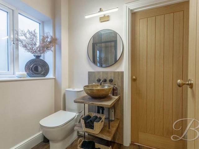 The first of the four bedrooms sits on the ground floor of the Mansfield house. Although we don't have a photo of it, here is its en suite shower room, with hand wash basin and low-flush WC.