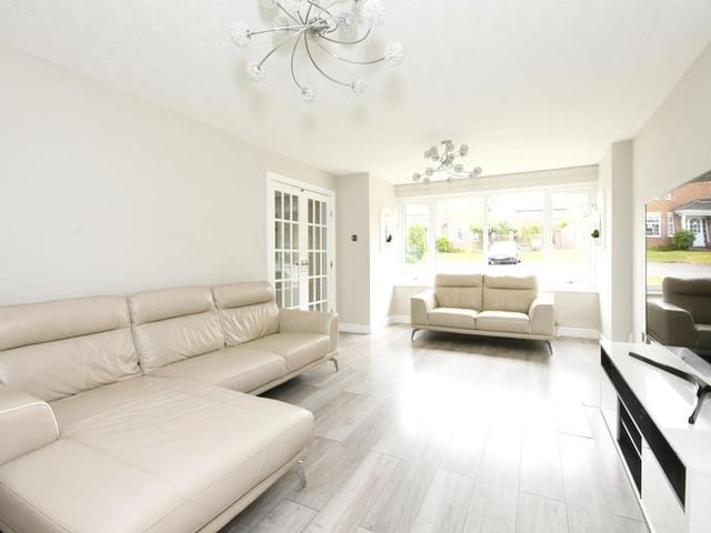 The lounge from a different angle. See how bright the room is thanks to natural light flooding through large windows that overlook the front of the property.