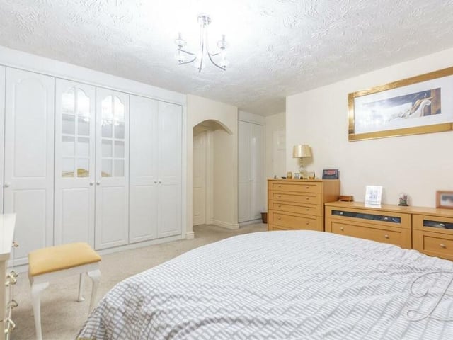 The master bedroom also features extensive fitted wardrobes, plus access to en suite facilities.