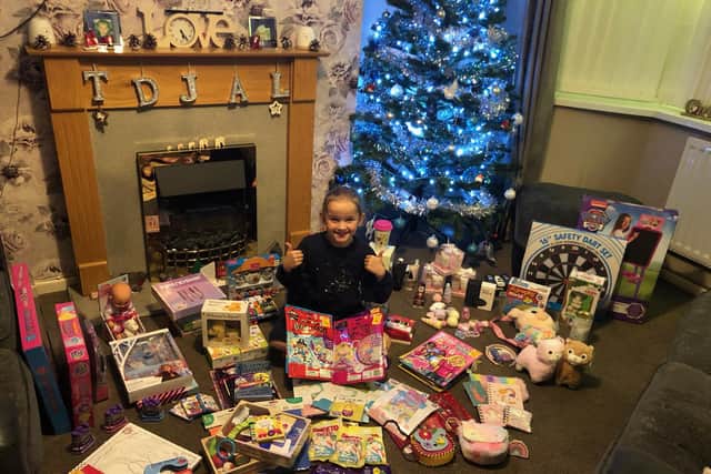 Lilly-May Hopcroft-Beecham, eight, surrounded by her gift donations.