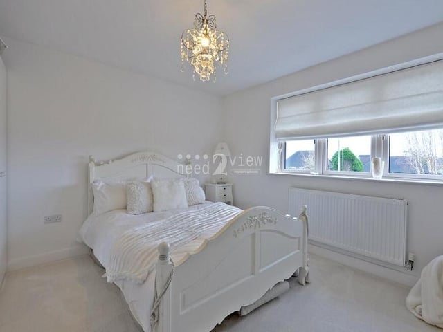 The fourth and final bedroom on the first floor has a touch of elegance about it, don't you think?