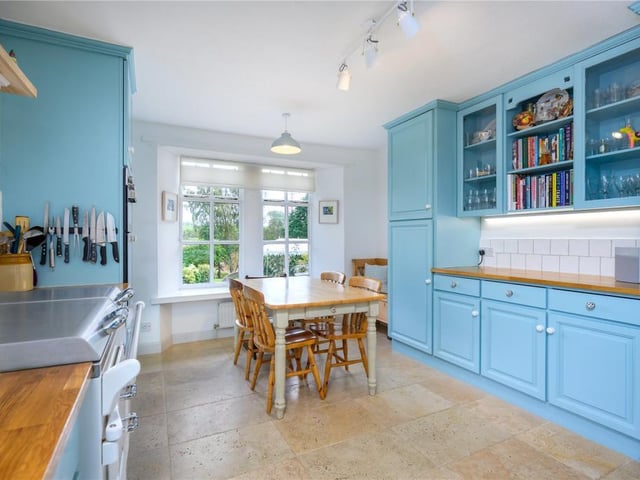 The kitchen has lovely painted units and a white Everhot range cooker.